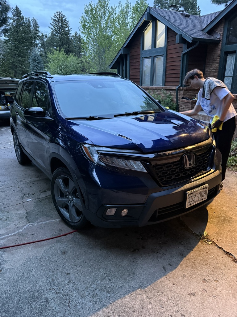 Working the wash mitt across a Honda Passport panel